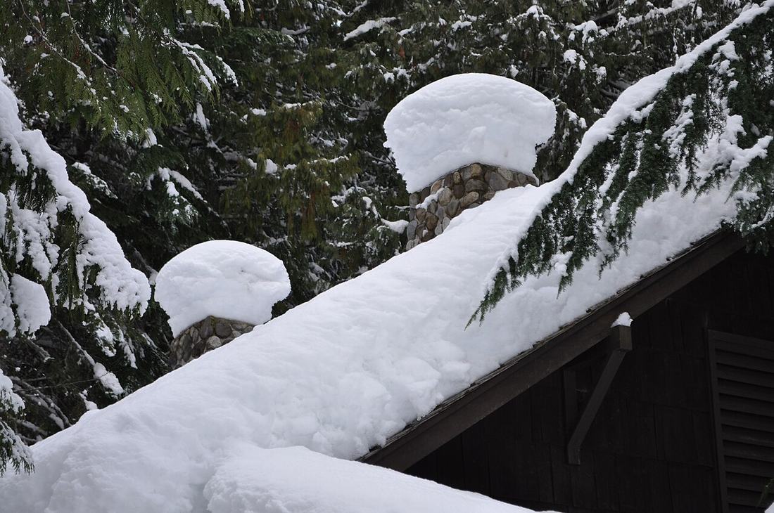 A house roof piled with snow