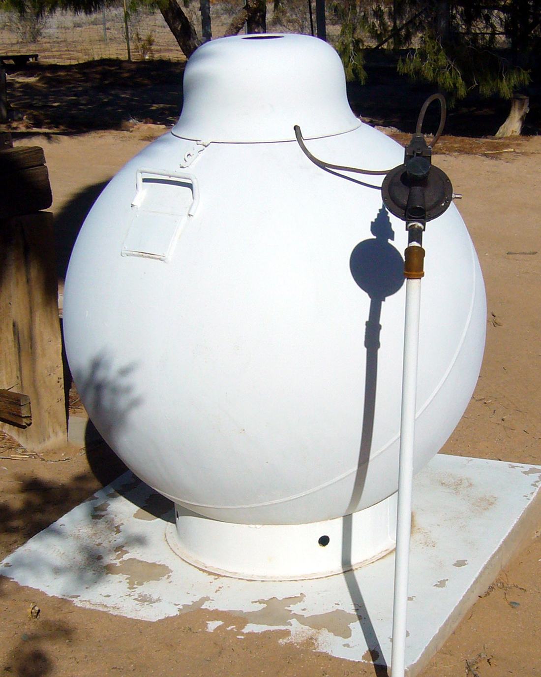A propane tank beside a home