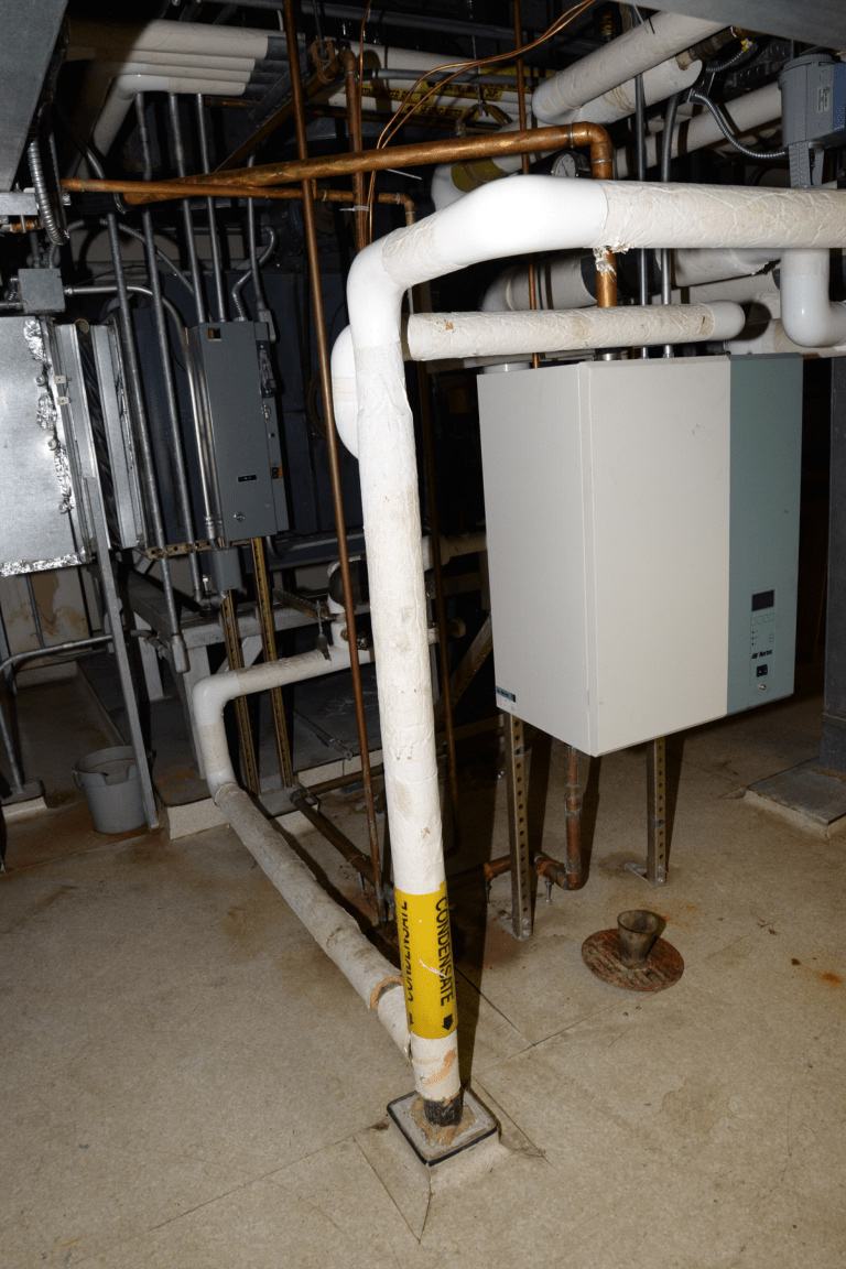 A basement utility area with a furnace unit